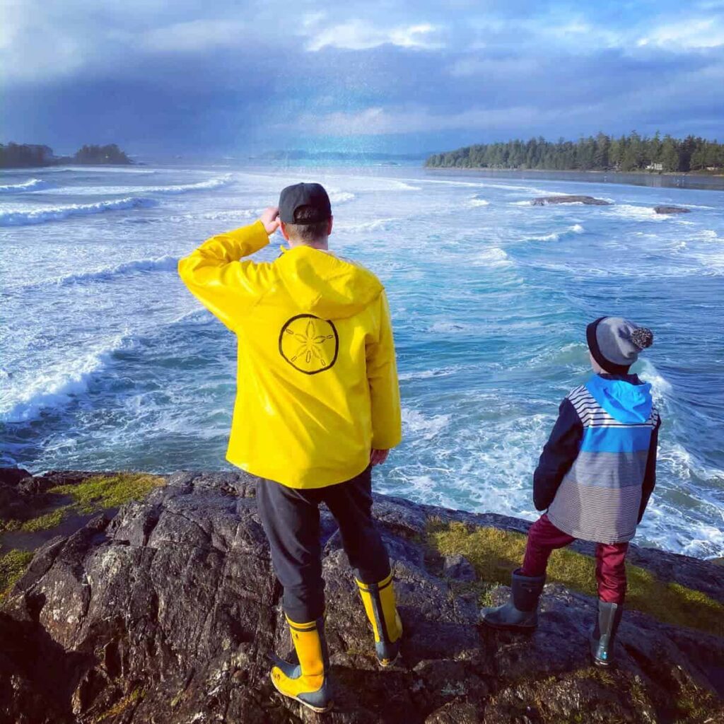 father and son at lookout over ocean in tofino