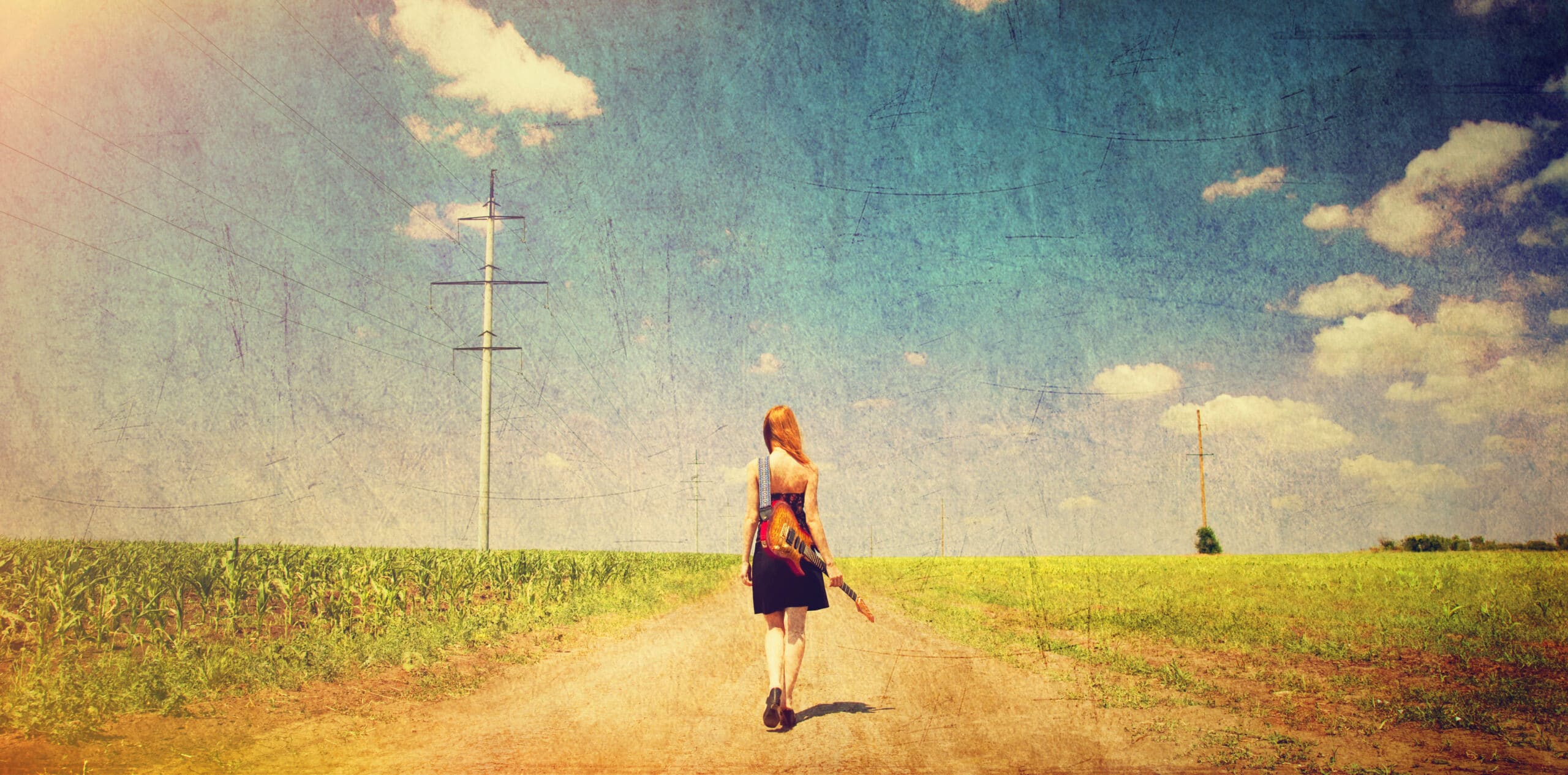 girl walking down the road with guitar