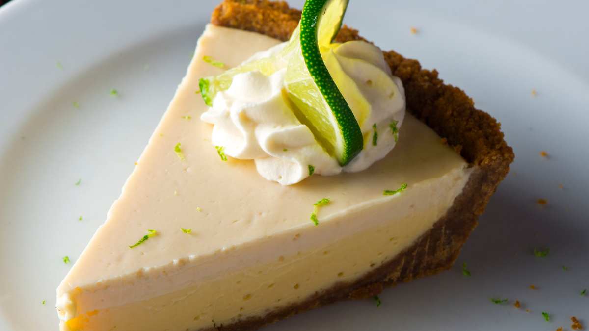 Key Lime Pie. Classic traditional American dessert favorite. Key lime pie, raw mixture made with the juice from Key West lime juice, condensed milk sugar and eggs poured into graham cracker crust.