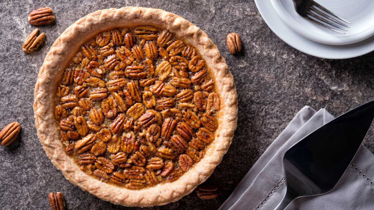 A delicious home made pecan pie on a stone counter top.