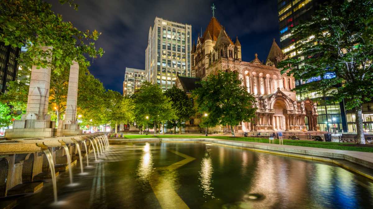 Fountains and Trinity Church at Copley Square at night, in Boston, Massachusetts.