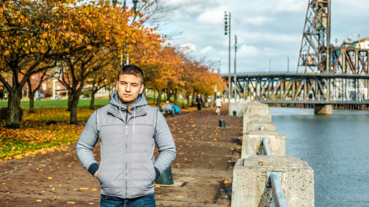 Man walking along the riverwalk in Portland city at autumn, Oregon, USA.