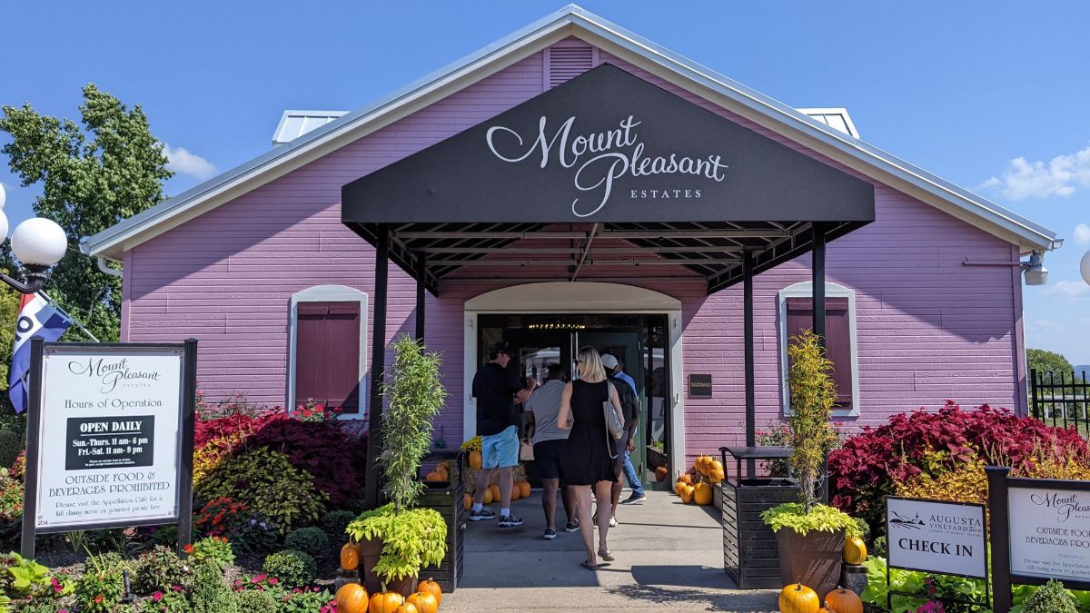 woman walking into winery in augusta is one of the best things to do in missouri