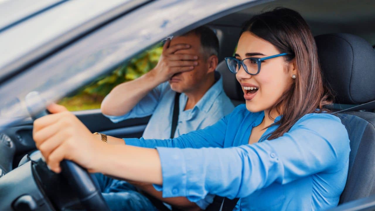 Woman Driver - Car Accident, yells in fear or frustration. Student girl sitting scared in a car. incident happens. Car Crash Accident with a Scared Driver and a instructor