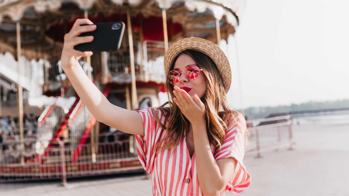 Woman taking selfie in theme park