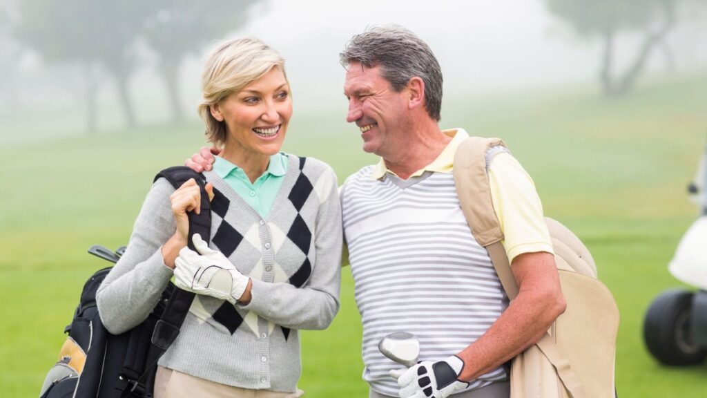 man and woman smiling on golf course