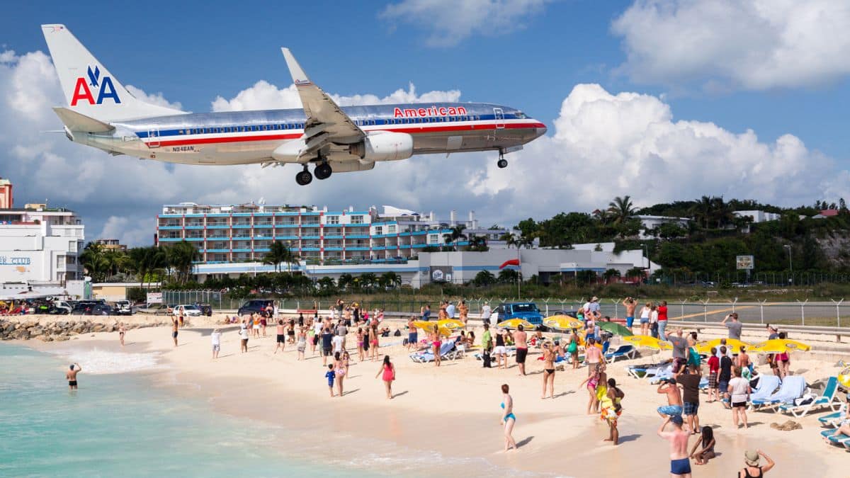 plane flying over beach in sint maarten