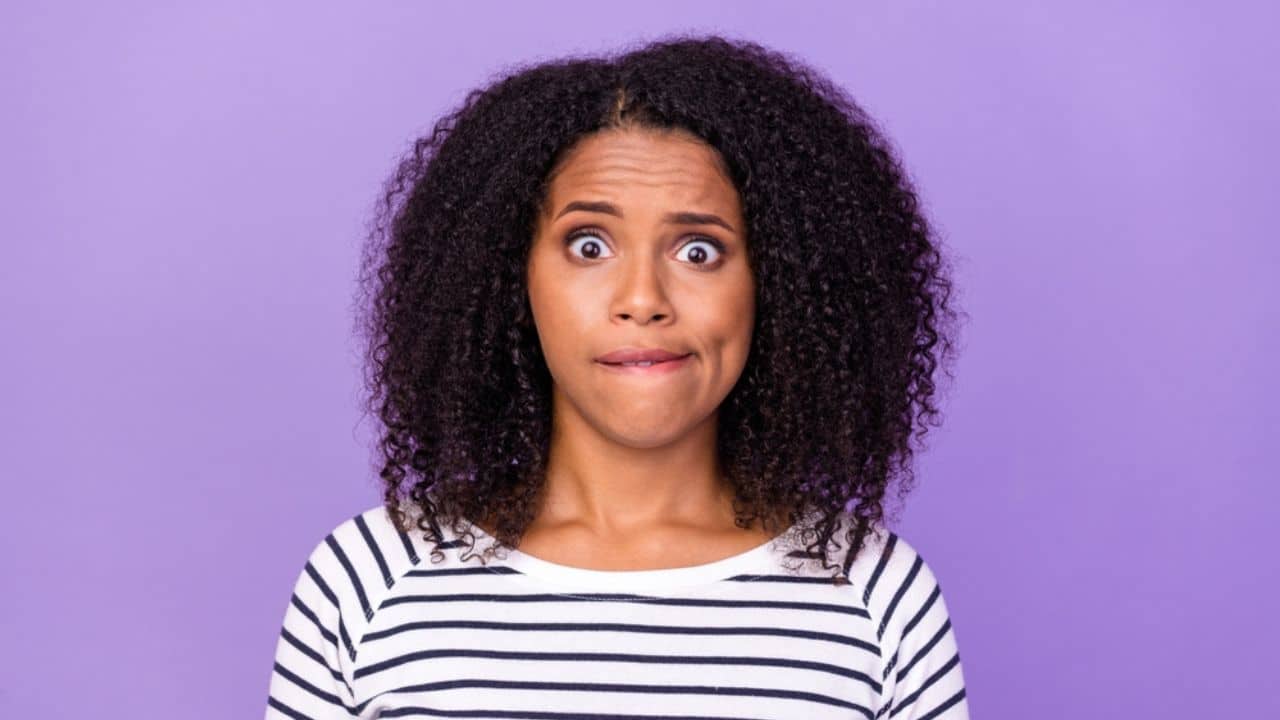 Portrait of shocked amazed stressed girl staring hear unexpected news information isolated on violet color background