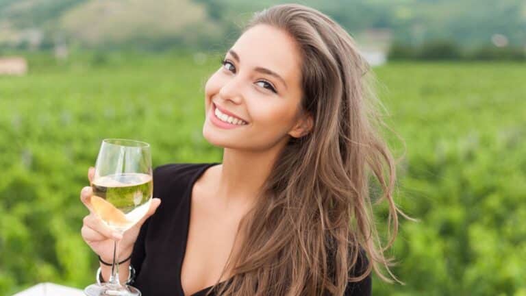 Outdoors portrait of a beautiful wine tasting tourist woman.