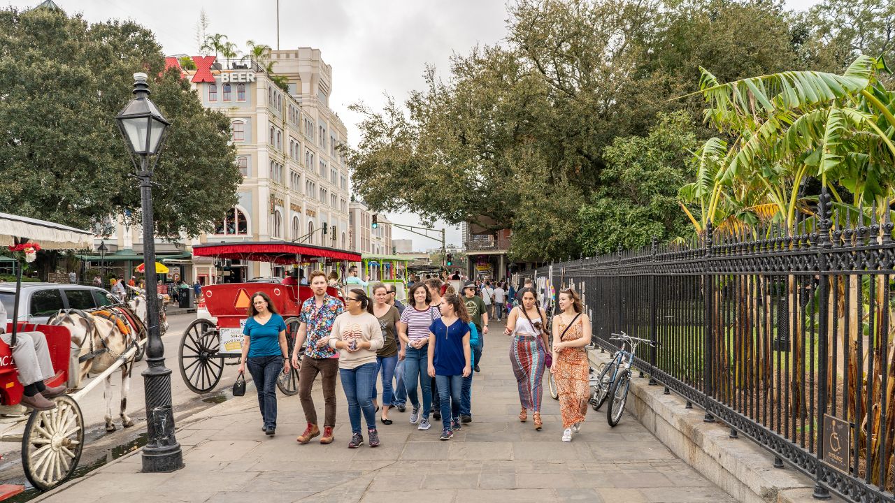 A group of friends enjoy the day on new orleans tours around Jackson Square, in the French Quarter. Millions visit New Orleans yearly.