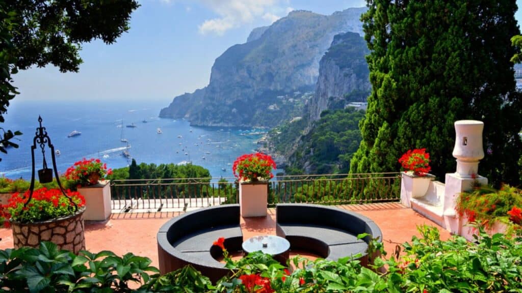 Flower filled terrace overlooking the coast of the popular tourist destination, the island of Capri, Italy