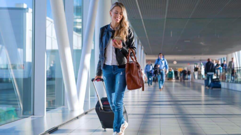 Happy woman traveling and walking in airport