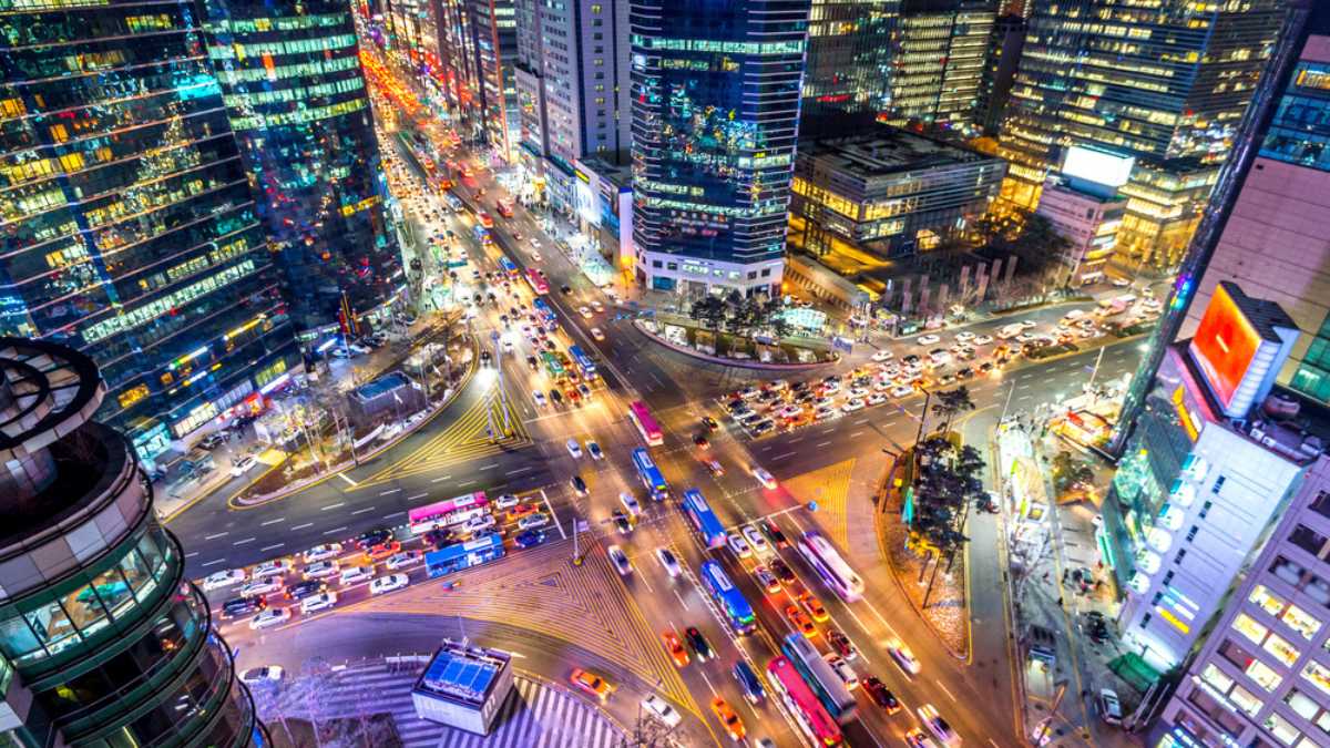 Traffic speeds through an intersection at night in Gangnam, Seoul in South Korea.