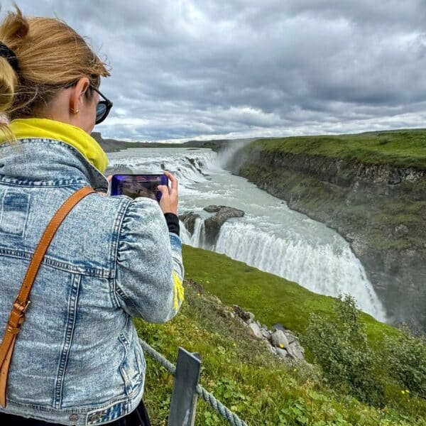 Gullfoss, Iceland - August 12, 2024: A woman taking pictures at Gullfoss Falls in Iceland